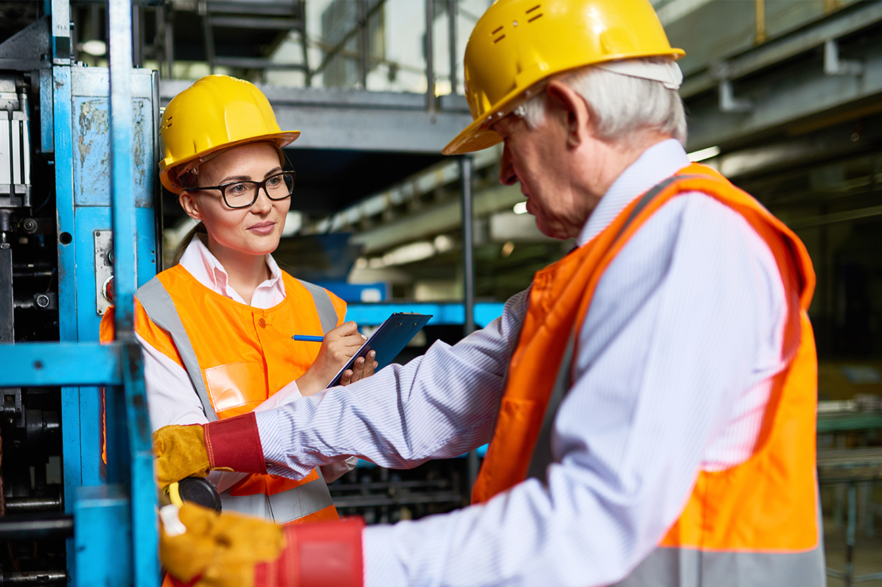 A manager talking to an employee on a warehouse floor