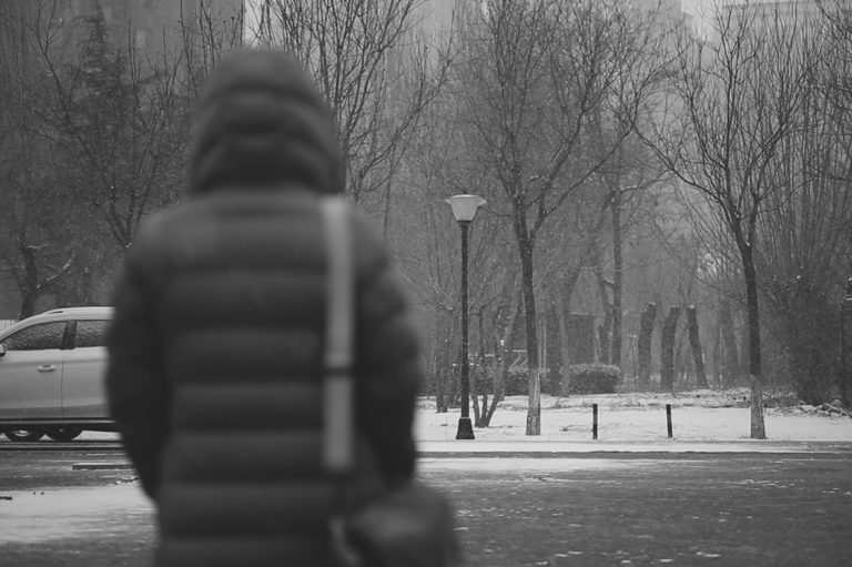 A person walking during winter. Video highlights dangers of falls in parking lots.