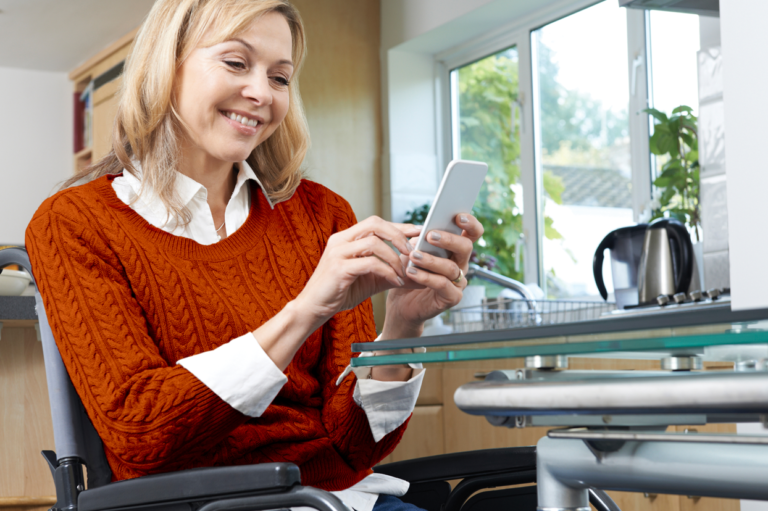 A person holding her phone. Learn how staying in contact with injured employees can prevent litigation.