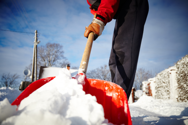 A person shoveling snow. Learn safety tips for shoveling.
