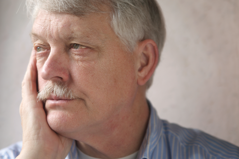 A pensive older man. Learn about how retirement presumption can impact work comp benefits.