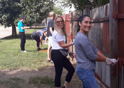 Painting a fence at Cornerstone