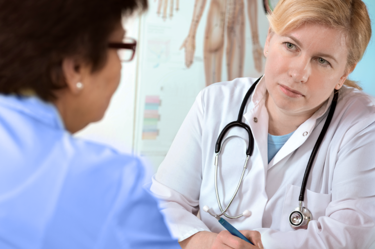 A doctor and a patient. Learn why employers should get to know medical providers.