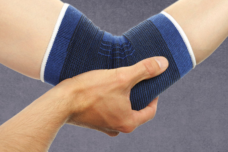 A person with a compression band around their elbow. Read about the value of reporting minor work injuries.