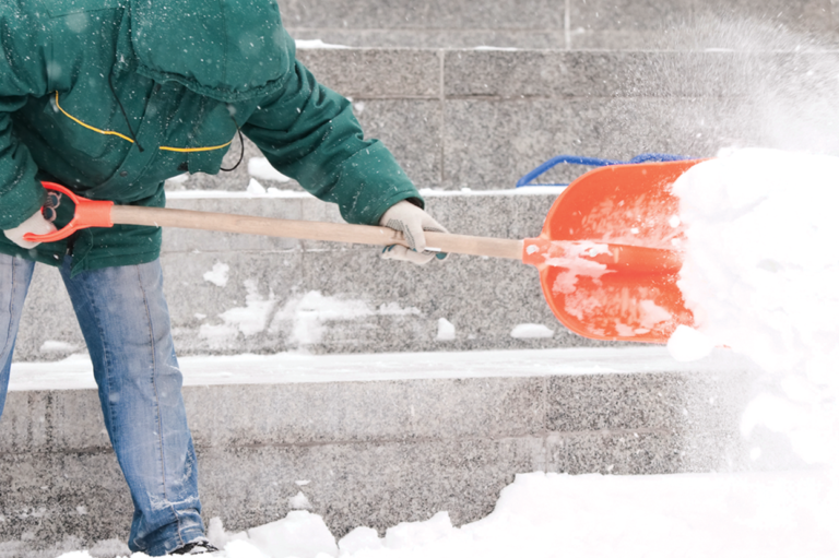 A person shoveling. Learn about injuries while entering or leaving the workplace.