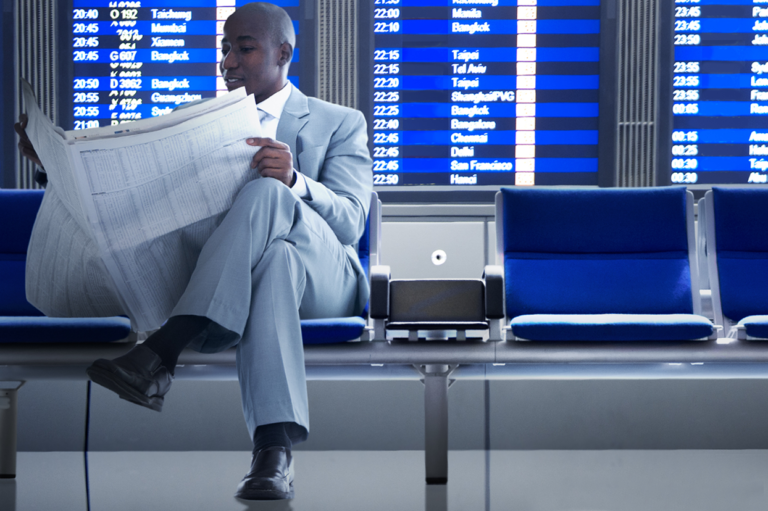 A traveler at an airport. Learn whether employees who are working overseas are covered by work comp.