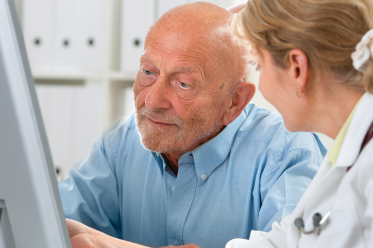A doctor talking to an older patient. Read about seven things employers should know about independent medical examinations.