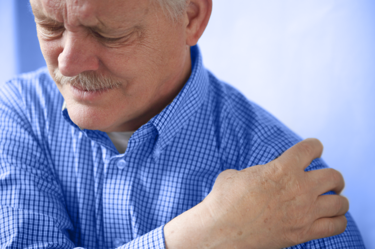 An older man clutching his shoulder. Learn about preventing injuries among aging workers.