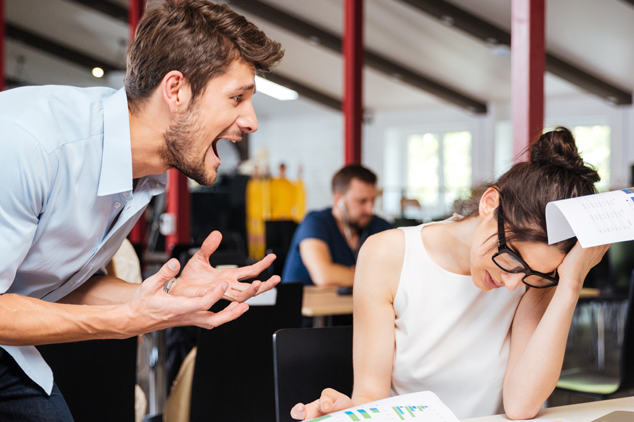 A man yelling at a coworker in an office