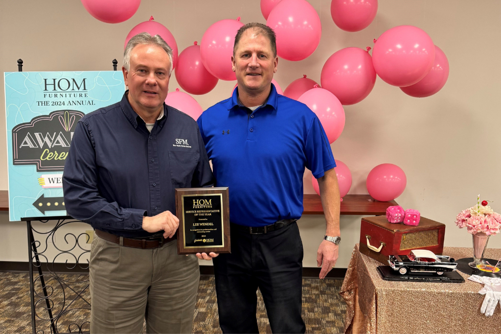 Dan Lentz (right), Safety Manager/HR Representative at HOM Furniture, presents Lee Wendel, Director of Loss Prevention at SFM, with the retailer’s Service Representative of the Year award