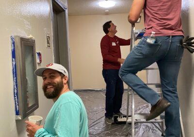 Employees paint hallways at a Project for Pride in Living property