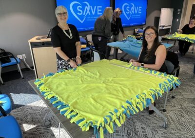 Employees made fleece tie blankets to benefit Suicide Awareness Voices of Education