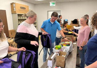 Employees donated school supplies to fill backpacks for kids supported by Project for Pride in Living